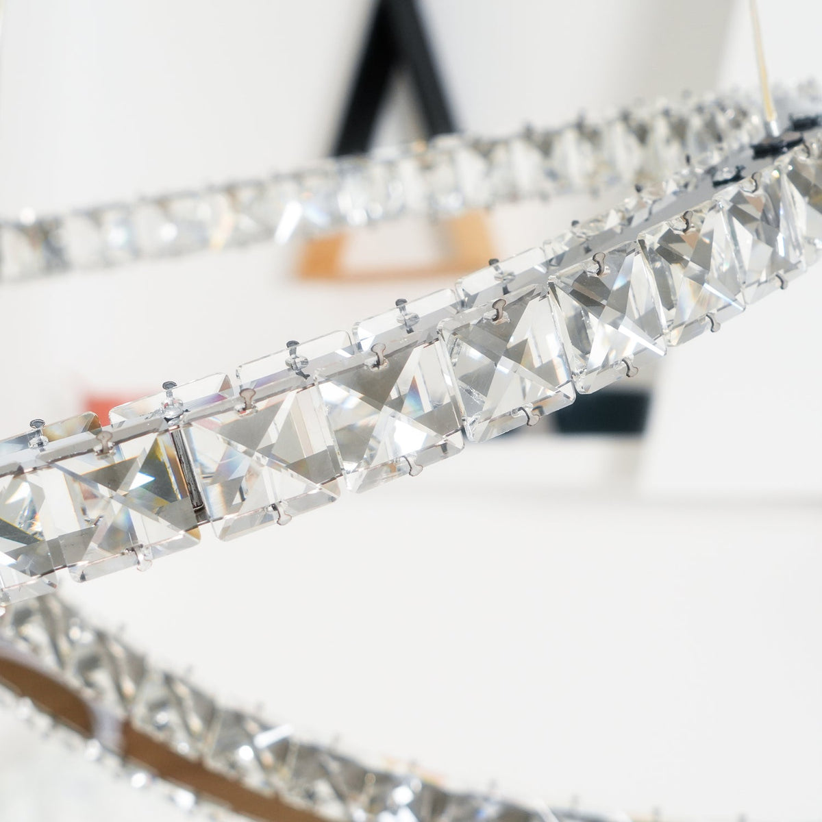 Close view of the square-cut crystals set along one crescent of this Clérachic pendant.