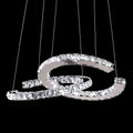 Clear-crystal Clérachic pendant lit on black, with six fine cables holding the two crescents.