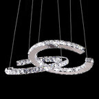 Clear-crystal Clérachic pendant lit on black, with six fine cables holding the two crescents.