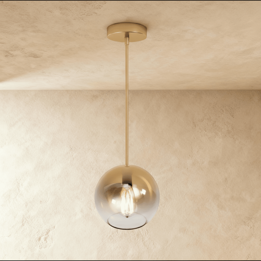 Clérachic champagne glass sphere pendant hangs against a warm plaster ceiling, its Edison bulb glowing inside.
