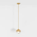 Clérachic gold-toned pendant light shown full drop, glass sphere shade lit from within on a white backdrop.