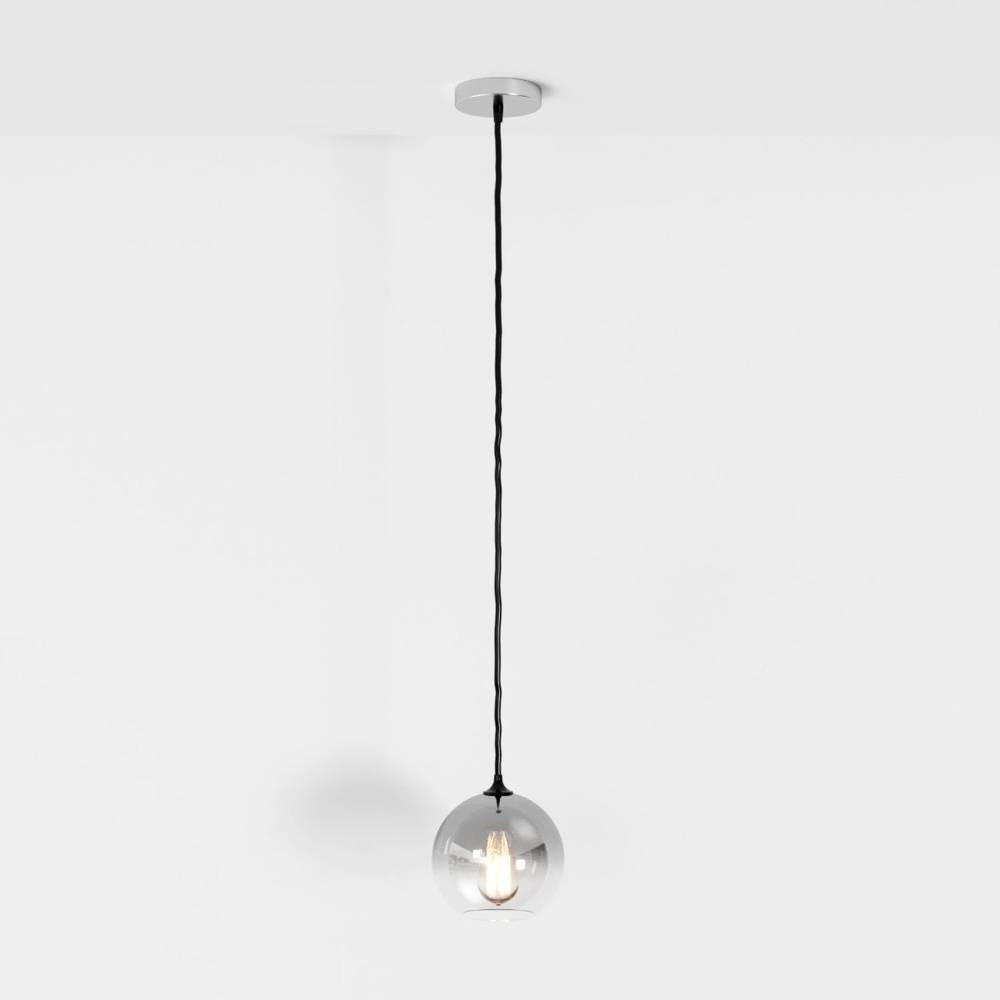 Clérachic silver-finish pendant light hangs on a black cord, glass sphere shade lit against a white backdrop.