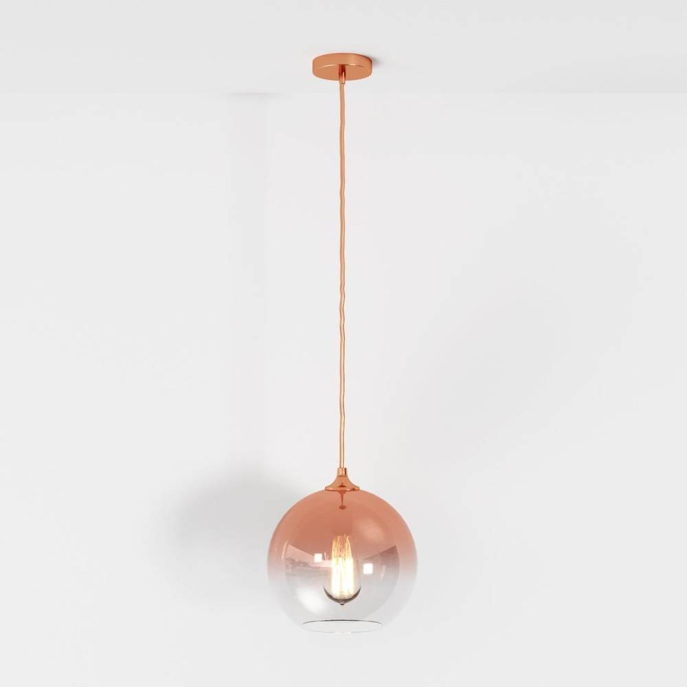 Clérachic rose gold glass sphere pendant shown at full drop length, filament bulb lit on a white studio ground.