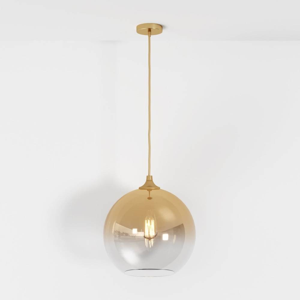 Clérachic champagne glass sphere pendant shown at full drop length, filament bulb lit on a white studio ground.