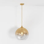 Clérachic champagne glass sphere pendant shown at full drop length, filament bulb lit on a white studio ground.