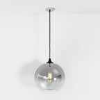 Clérachic silver-finish glass sphere pendant on a black cord, dark hardware visible at the shade's fitter.
