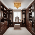Gold-toned Clérachic chain ceiling light above a dark wood walk-in wardrobe with a dressing table and a pale ottoman.