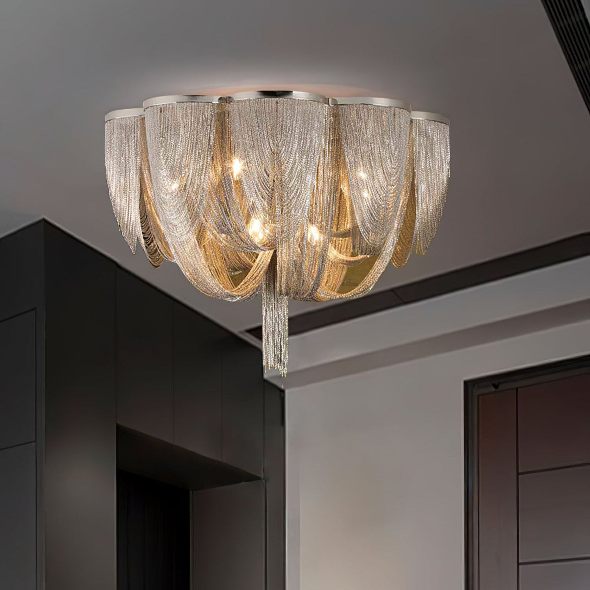 Clérachic chain ceiling light hung in a dark-walled room with a grey ceiling and a dark door at the right.