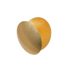 Angled view of this Clérachic wall light in gold, the front disc tilted out to show a deeper amber disc behind it, on white.