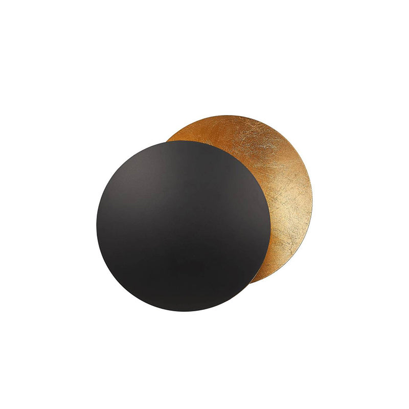 Black front disc over a gold-leaf disc on this Clérachic wall light, shown on a plain white backdrop.