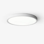 This Clérachic slim round ceiling light has a white metal rim and a flat white acrylic diffuser, seen from below on a pale backdrop.