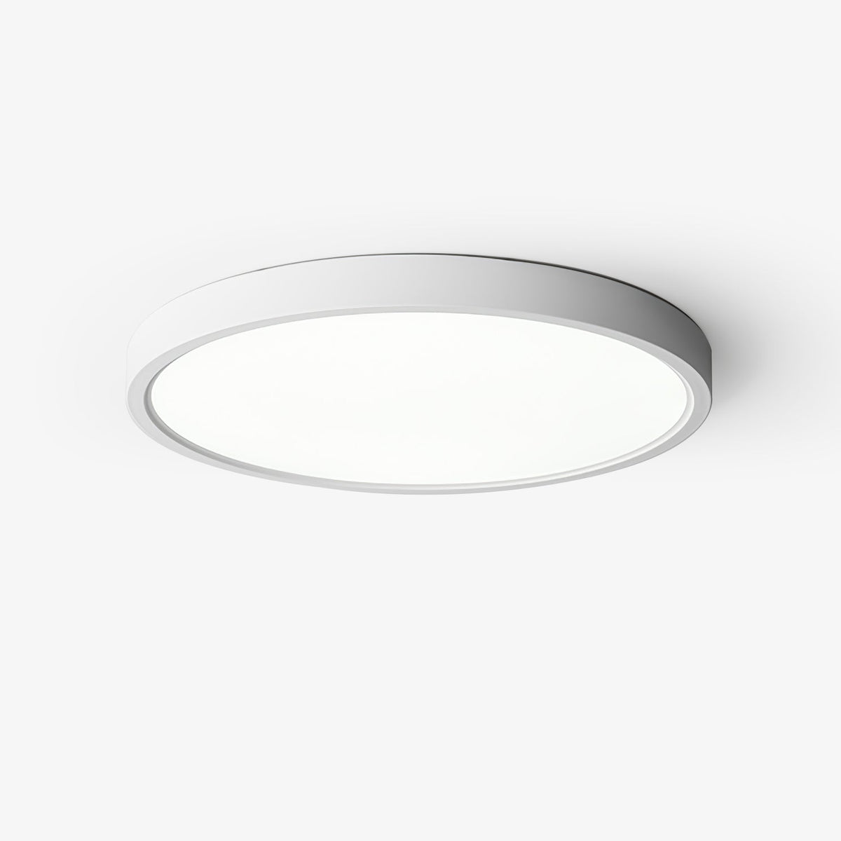 This Clérachic slim round ceiling light has a white metal rim and a flat white acrylic diffuser, seen from below on a pale backdrop.