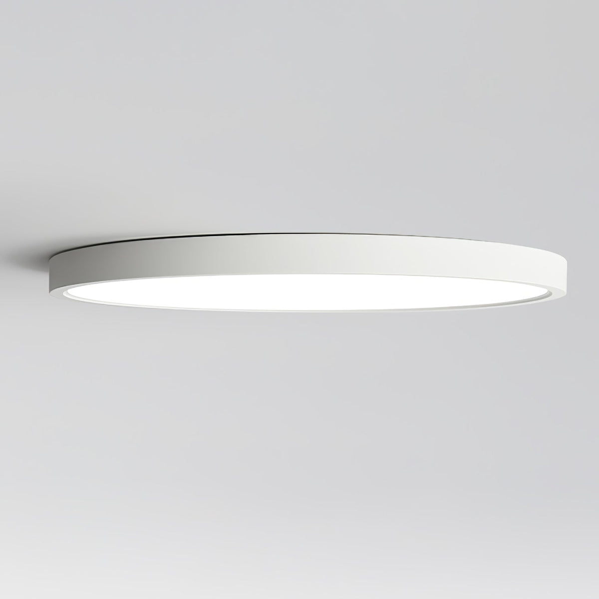 Side view of this Clérachic ceiling light, showing how thin the white rim is against a pale grey ceiling.