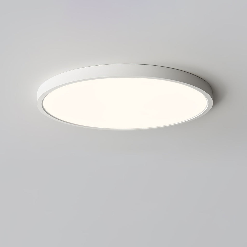 A white-rimmed Clérachic round ceiling light, lit with a soft warm glow, seen from slightly below on a grey ceiling.