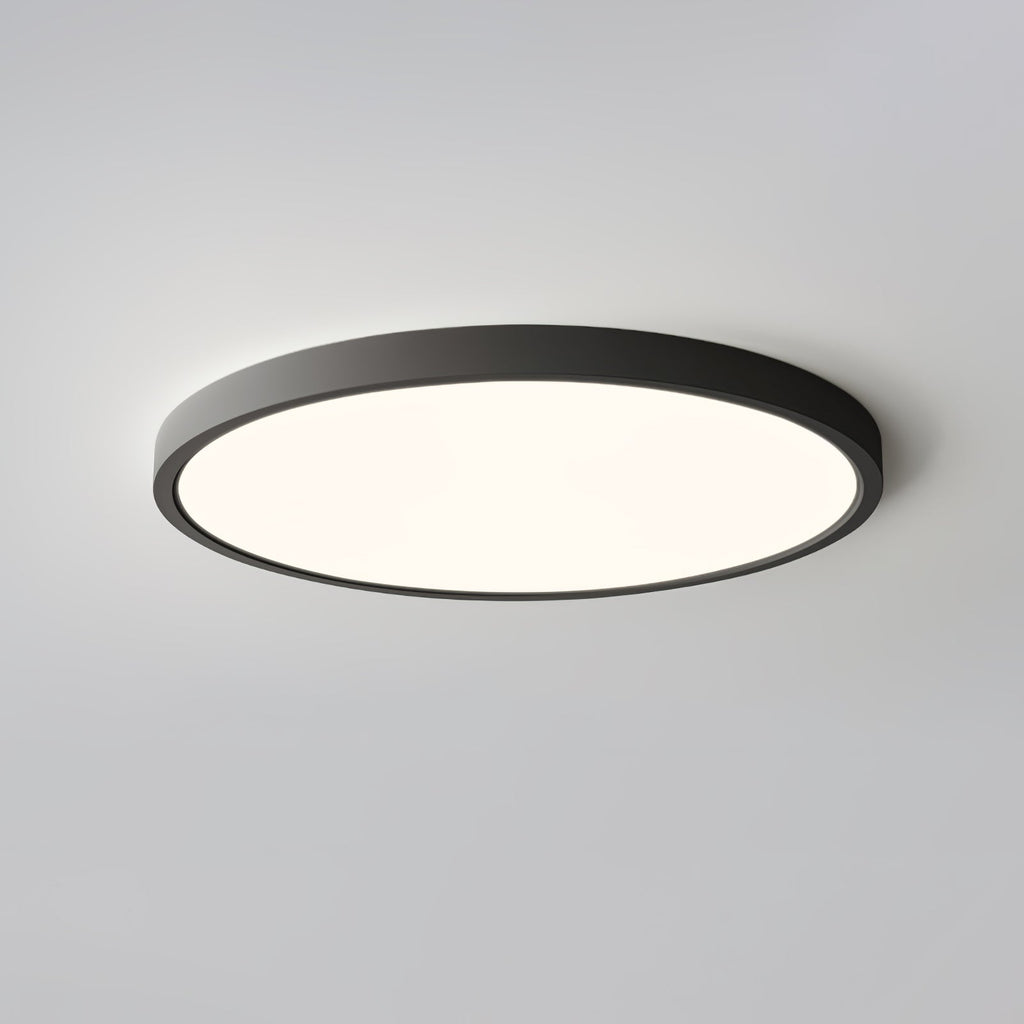 A black-rimmed Clérachic round ceiling light with a warm glow, seen from below against a pale grey ceiling.