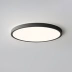 A black-rimmed Clérachic round ceiling light with a warm glow, seen from below against a pale grey ceiling.