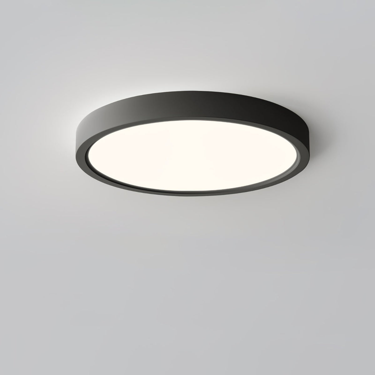 A black Clérachic round ceiling light with a softly lit diffuser, viewed at an angle to show the depth of its slim rim.