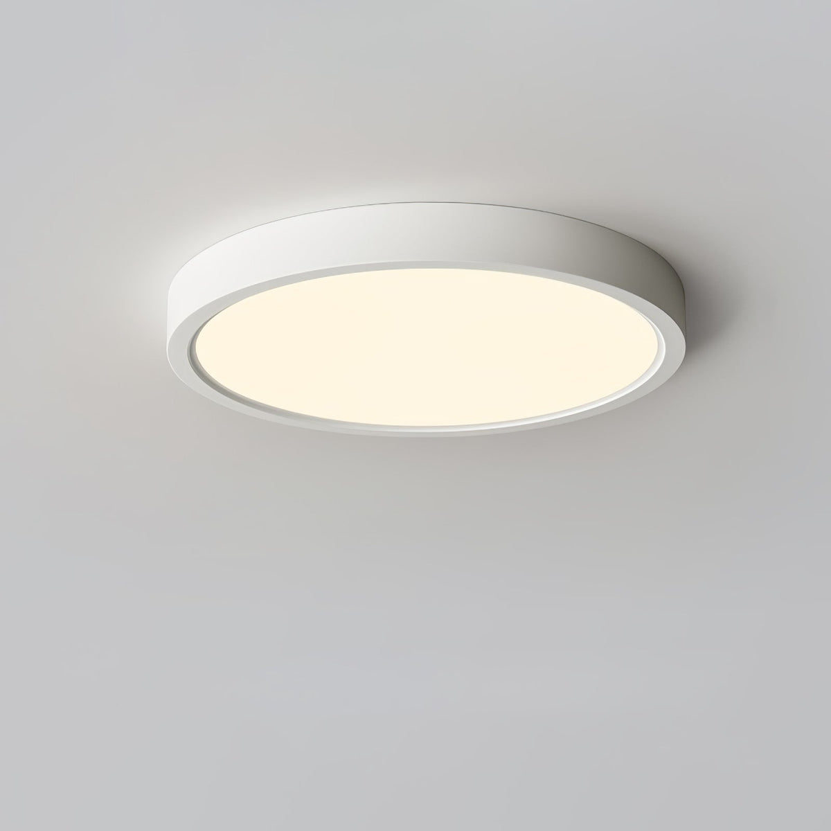 Warm golden glow from a white Clérachic round ceiling light, shown from below on a light grey ceiling.