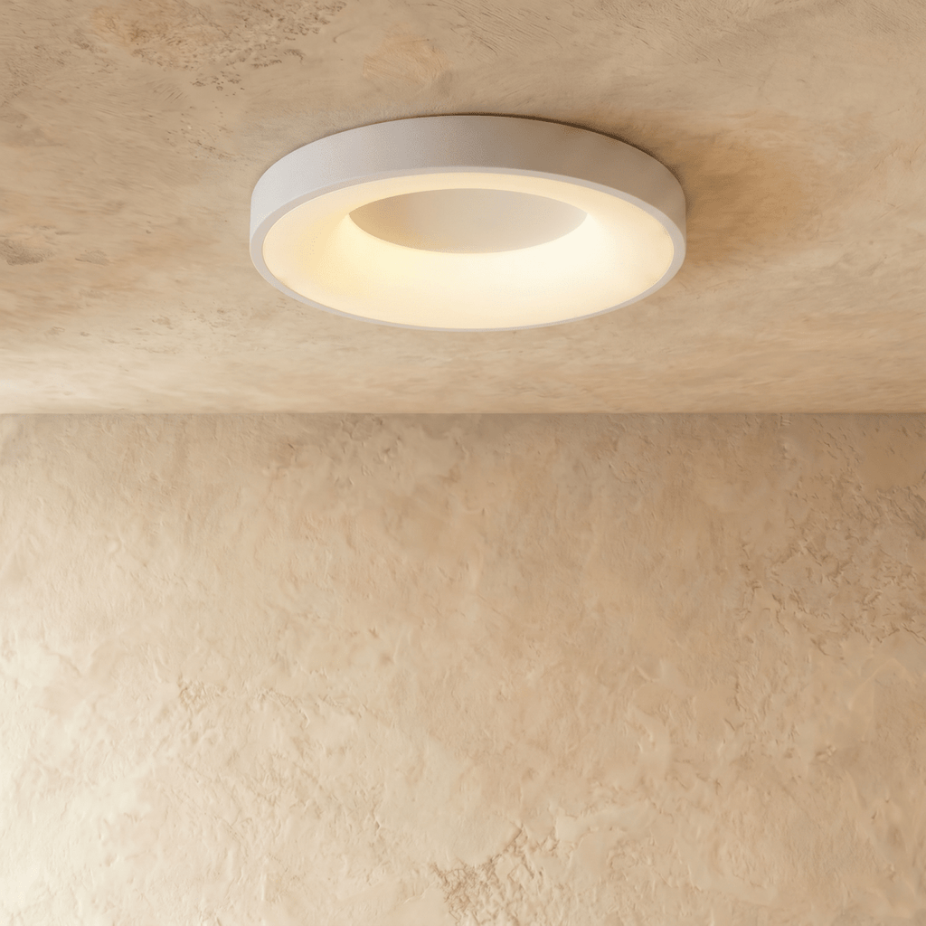 Clérachic white flat ceiling light, a larger diameter, with a soft glowing ring around its white centre.
