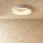 Clérachic white flat ceiling light, a larger diameter, with a soft glowing ring around its white centre.