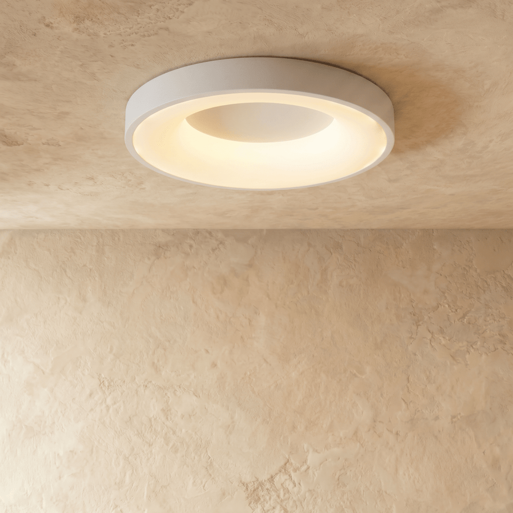 Clérachic largest white round ceiling light with a warm glowing ring, shown flush against a limewash ceiling.