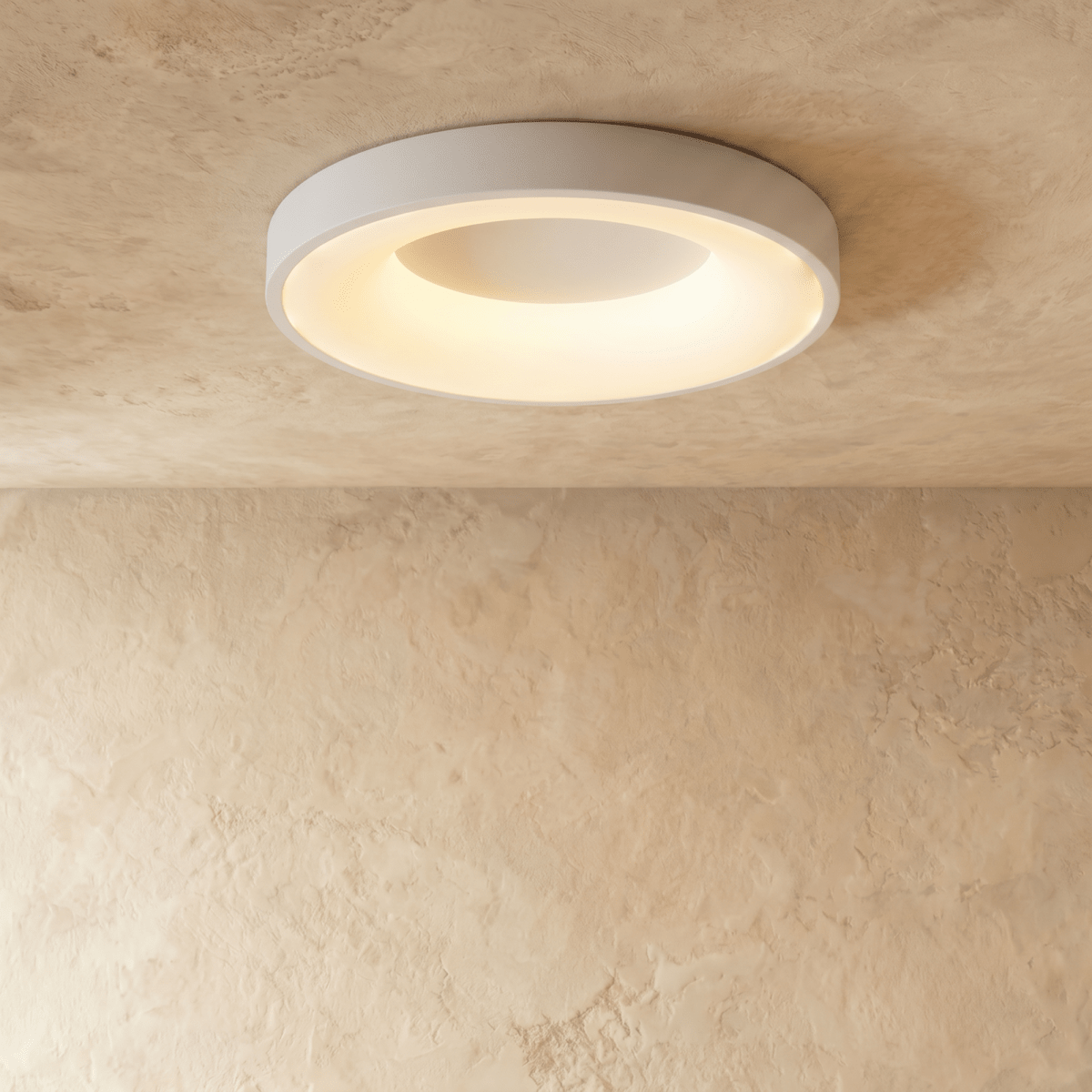 Clérachic largest white round ceiling light with a warm glowing ring, shown flush against a limewash ceiling.