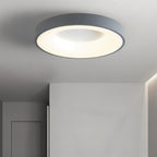 Clérachic grey round ceiling light glowing warm white in a pale grey hallway beside a plain wall and door.