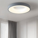 Clérachic grey round ceiling light in a calm bedroom corner, with grey curtains and a panelled wall beside it.
