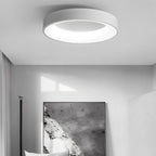 Clérachic white round ceiling light in a monochrome room with a large abstract print and a slim black floor lamp.