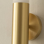 Detail of the brushed brass band and round wall plate of this Clérachic wall light, with the alabaster rising above it.