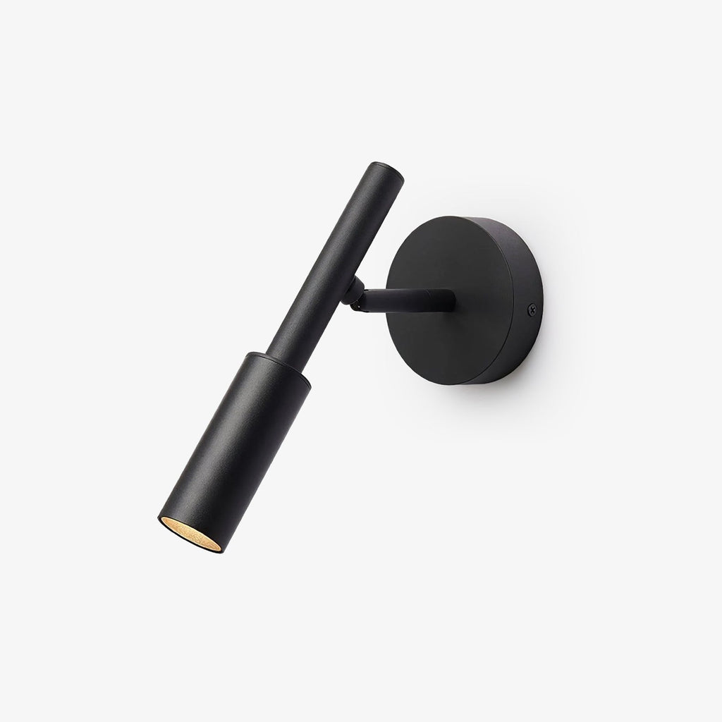 A black Clérachic wall light with a slim tube spot head on a short arm and a round backplate, on a white backdrop.