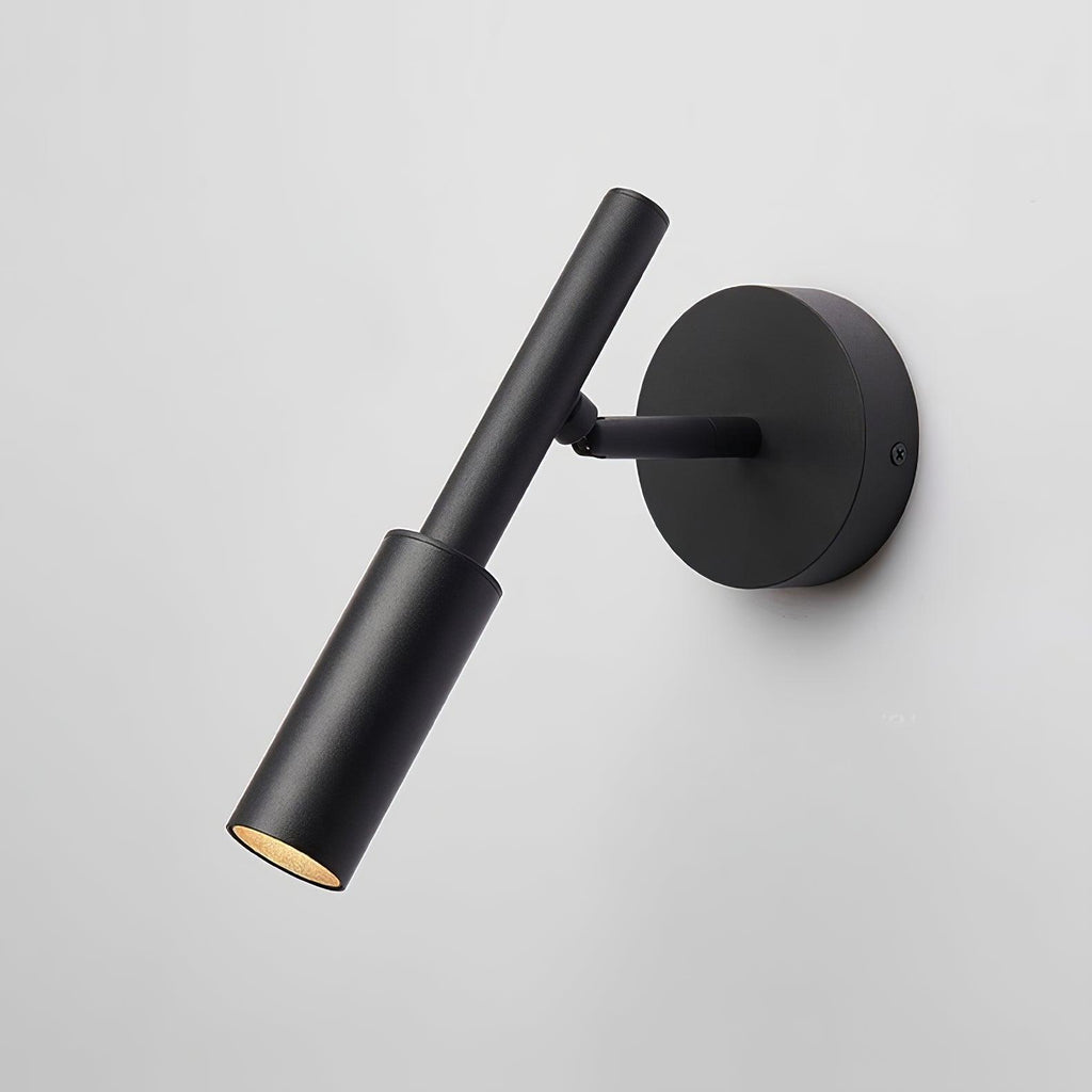 Angled view of a black Clérachic wall light with a slim tube head swivelled outward from its round backplate.