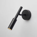Angled view of a black Clérachic wall light with a slim tube head swivelled outward from its round backplate.