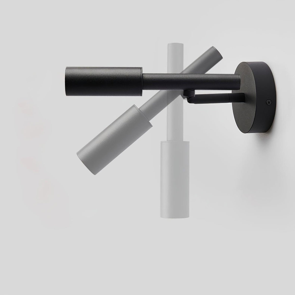 A black Clérachic wall light shown swung through its range, from hanging down to pointing out level from the wall.