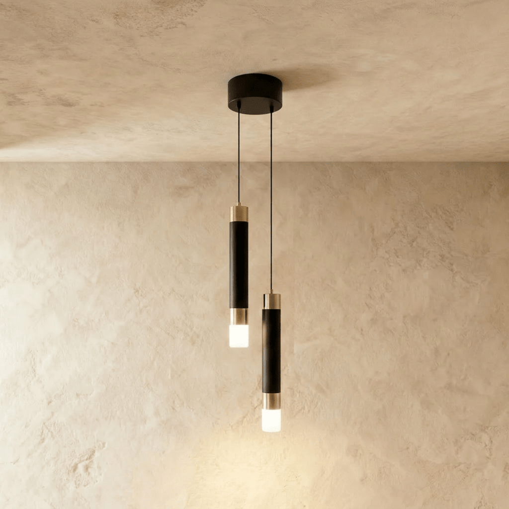 Clérachic two-head pendant light, black cylinders with gold-tone bands hanging at two heights from a round black canopy.