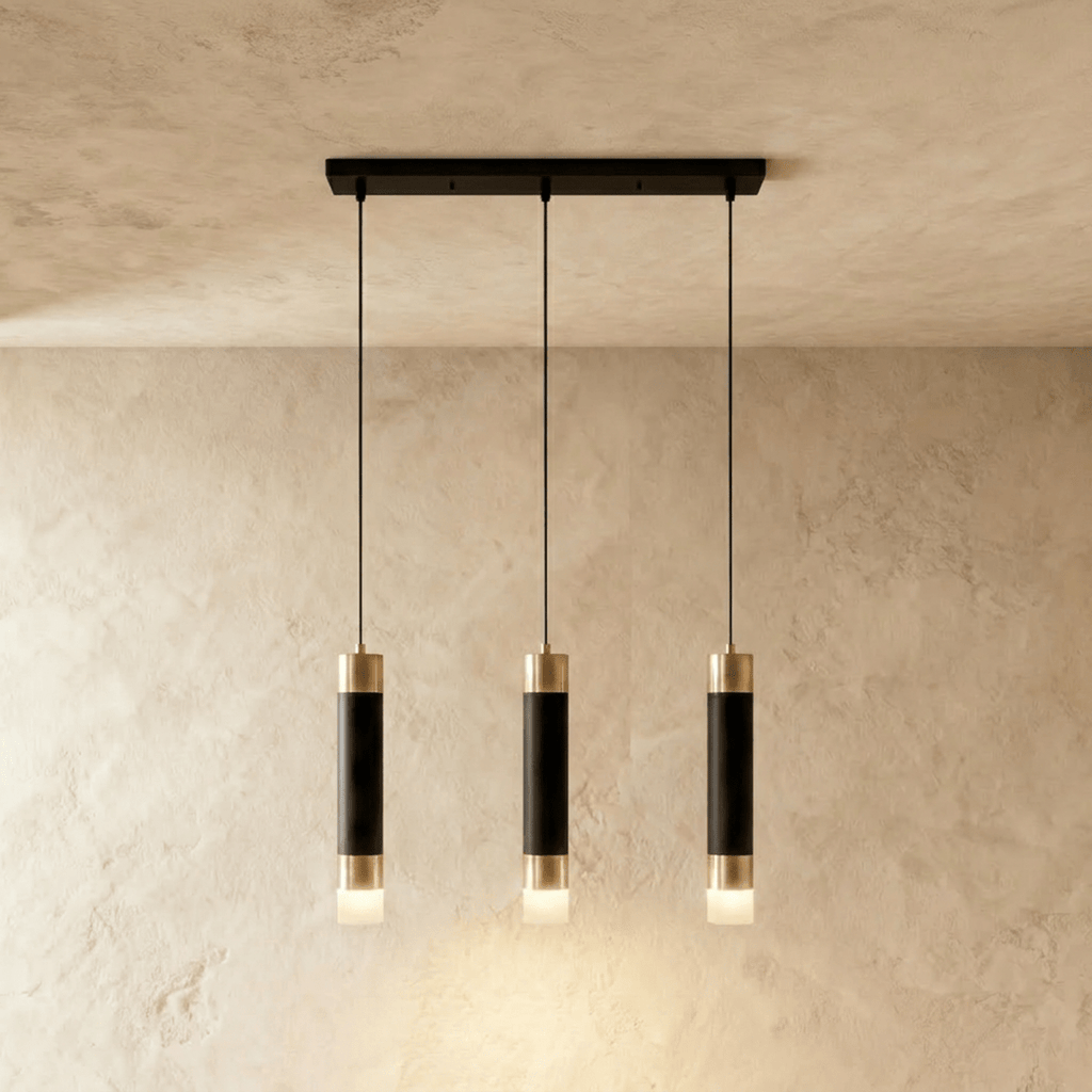Clérachic three-head pendant light, black gold-banded cylinders hung in a row from a slim rectangular black canopy.
