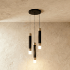 Clérachic three-head pendant light, black gold-banded cylinders at staggered heights from a round black canopy.