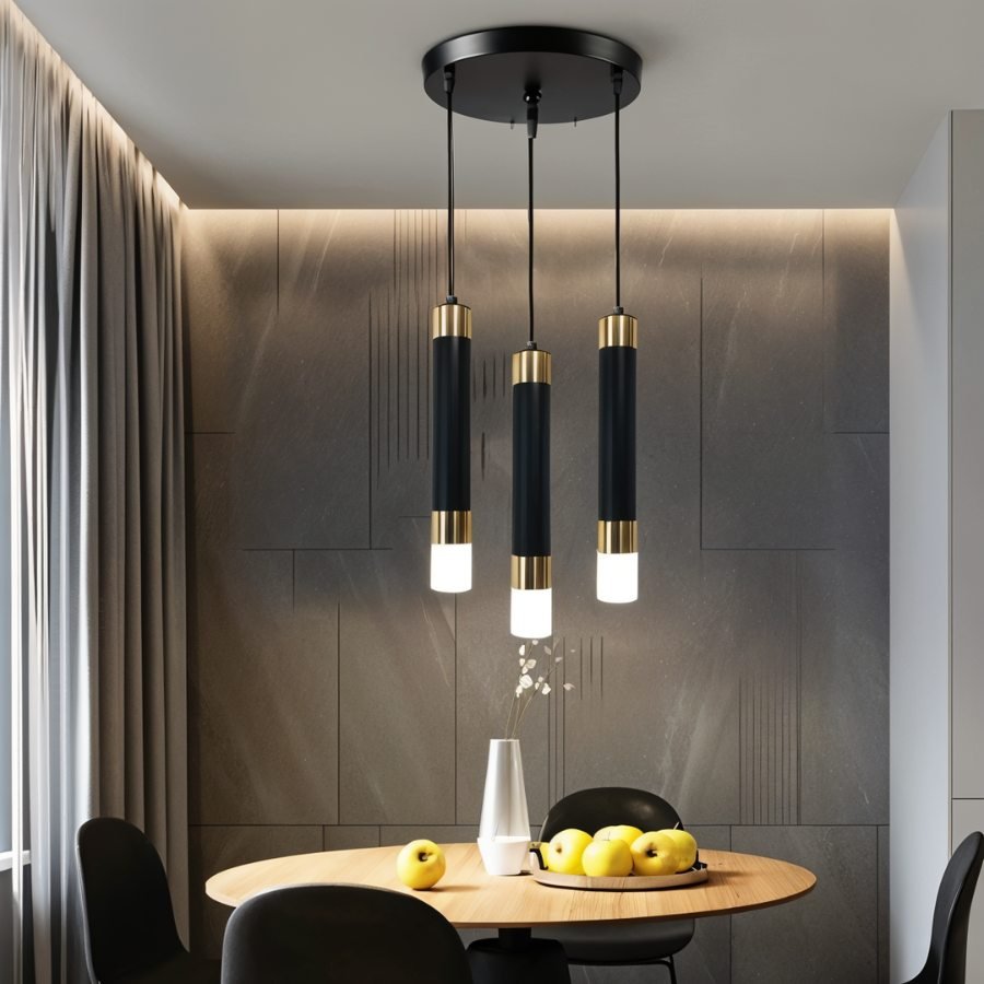 Clérachic round three-head pendant light with black gold-banded cylinders glowing above a small round dining table.