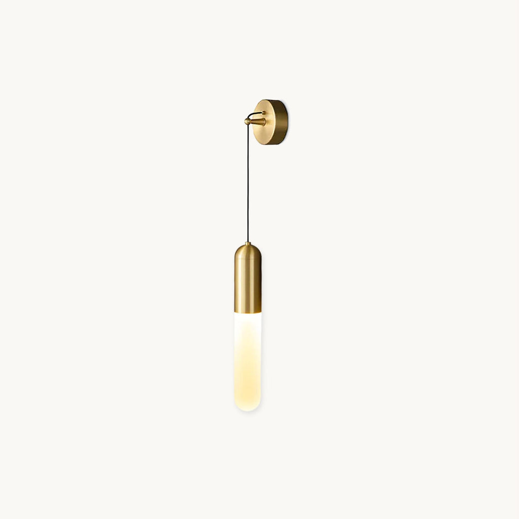 Brass Clérachic wall light on a plain white backdrop, a slim opaque cylinder shade hanging on a thin black cord from a round wall plate.