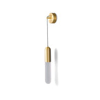Unlit brass Clérachic wall light on white, the frosted cylinder shade pale below a brass cap, with a soft shadow beside it.