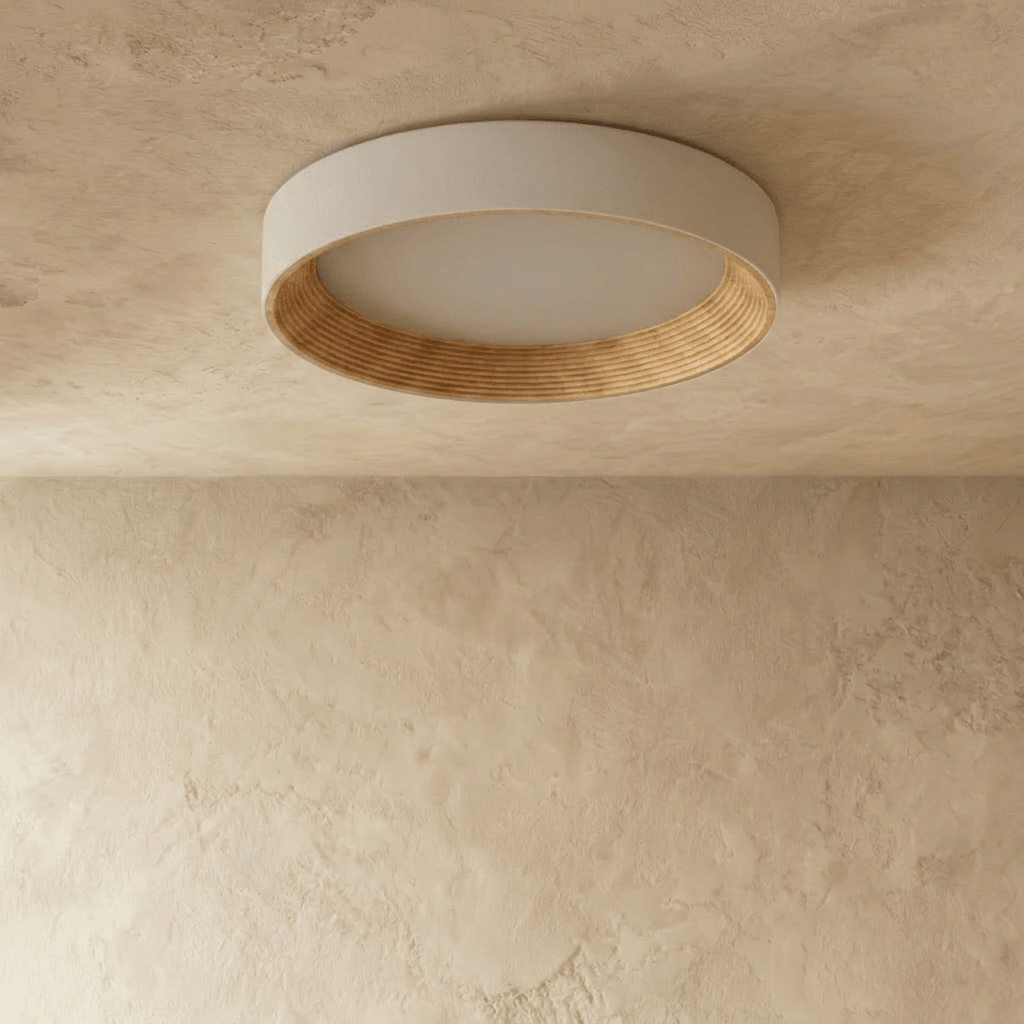 Clérachic large round flush ceiling light switched off, showing its pale rim, matte diffuser and ribbed light wood ring.