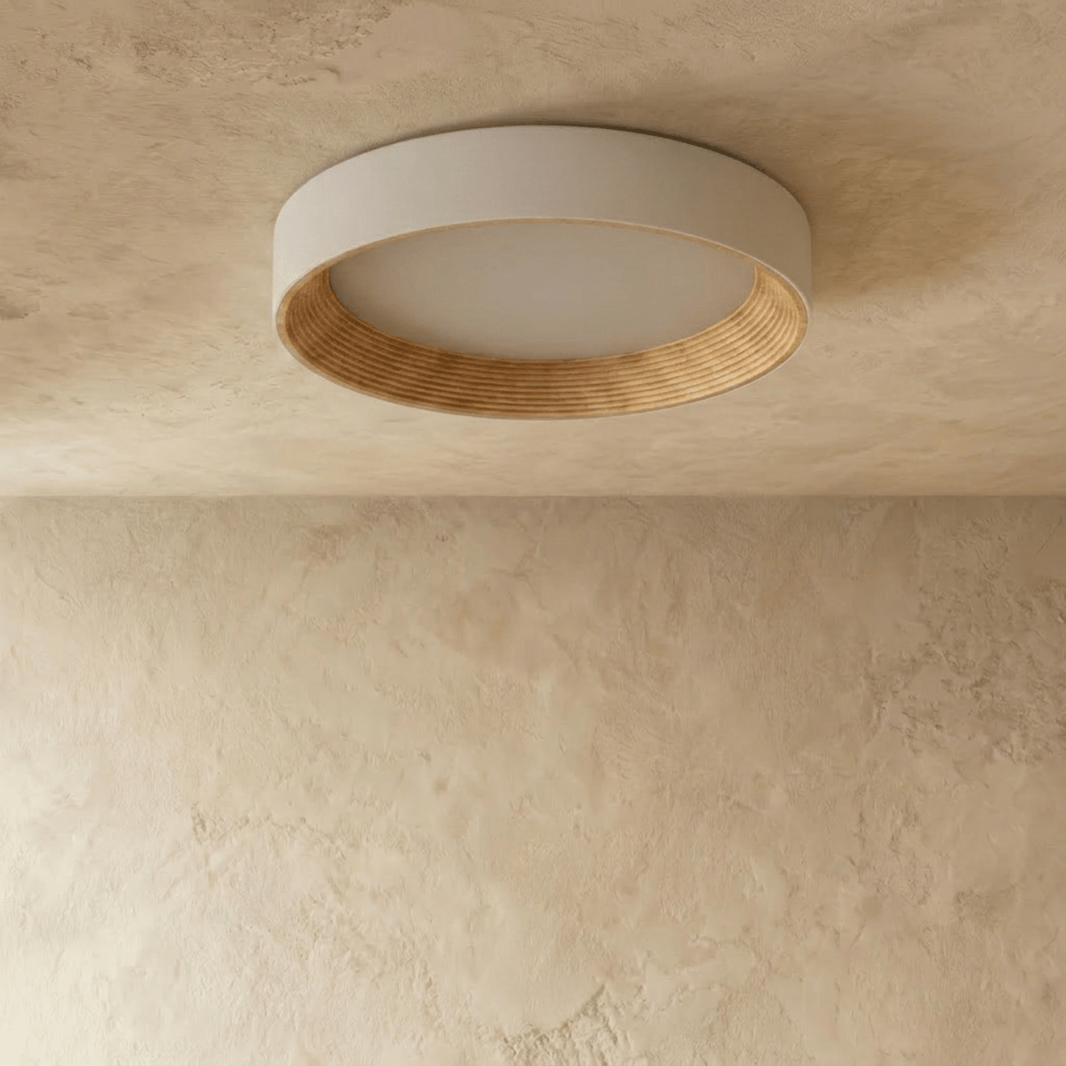 Clérachic large round flush ceiling light switched off, showing its pale rim, matte diffuser and ribbed light wood ring.