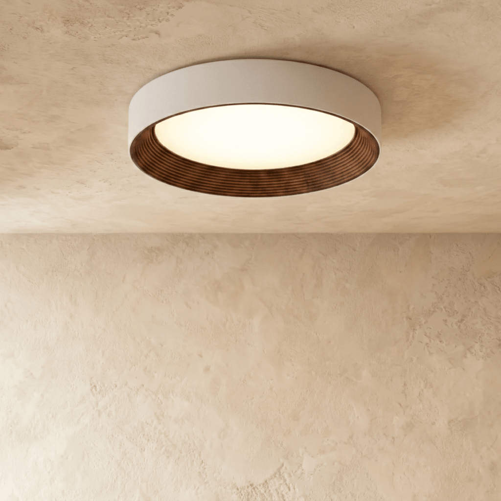 Clérachic largest round flush ceiling light with a pale rim and dark ribbed walnut-tone inner ring, softly lit on plaster.