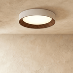 Clérachic largest round flush ceiling light with a pale rim and dark ribbed walnut-tone inner ring, softly lit on plaster.