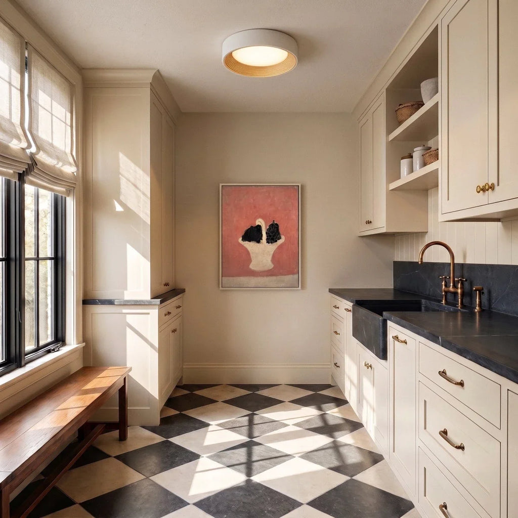 Clérachic round flush ceiling light with a pale rim and light wood ring above a cream room with a tiled floor and bench.