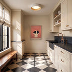 Clérachic round flush ceiling light with a pale rim and light wood ring above a cream room with a tiled floor and bench.