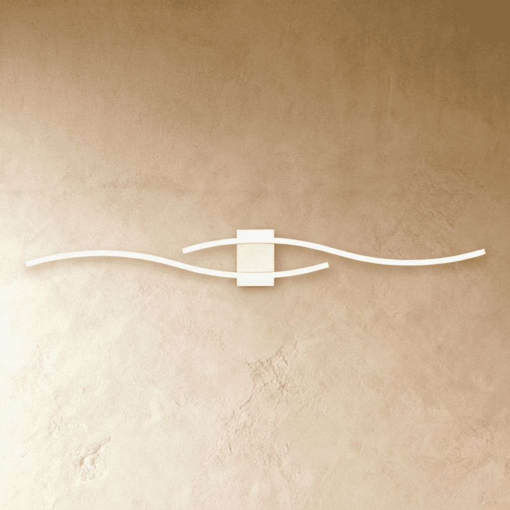 Clérachic slim white LED wall lamp with two wavy bars crossing on a square backplate, mounted on a warm limewashed wall.