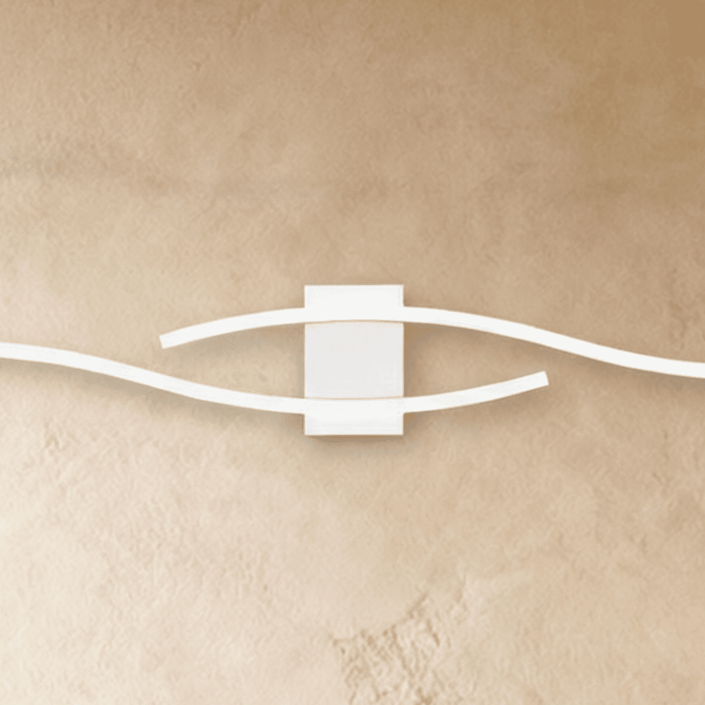 Close view of the Clérachic white wall lamp's square backplate with two wavy slim bars sweeping past each other.