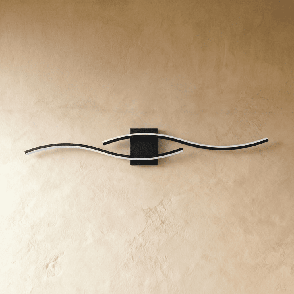 Clérachic black wavy wall lamp with two slim bars and a white diffuser edge, mounted on a limewashed wall.