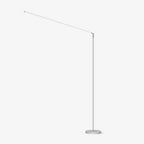 White version of this Clérachic slim floor lamp, with a thin upright pole, a long angled light arm and a round base, on a plain white backdrop.